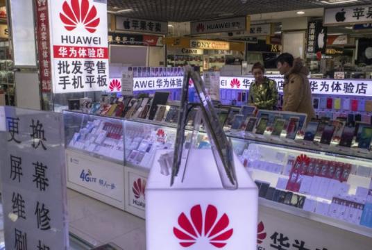 Customers browse a booth featuring Huawei products at a mall in Beijing, China, on Dec 17, 2018.PHOTO: NYTIMES