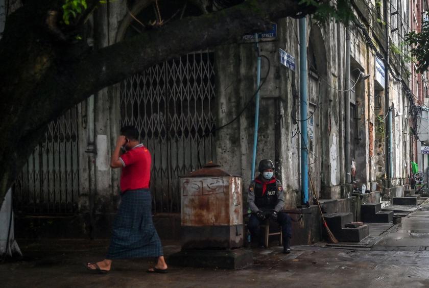 A member of the Myanmar security forces sits along a street in Yangon on July 19.Source: AFP/Getty Images