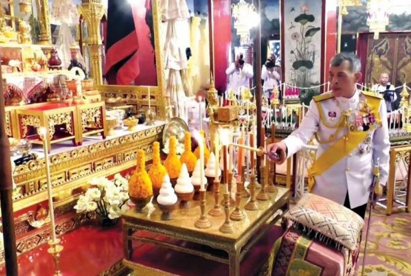 His Majesty King Maha Vajiralongkorn yesterday lights candles at the Baisal Daksin Throne Hall to consecrate the ceremonial objects which will be used in the coronation ceremony.