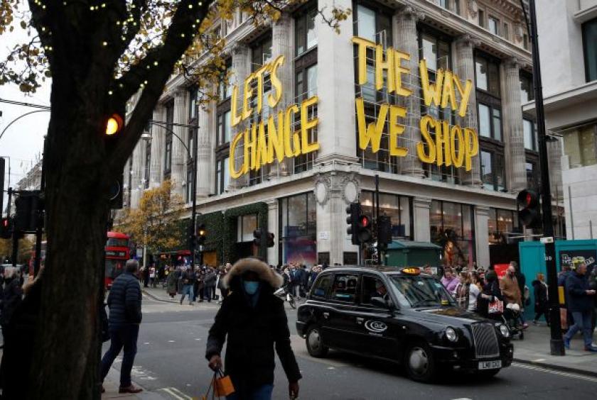 Christmas shoppers walk past the Selfridges store, amid the coronavirus disease (COVID-19) pandemic in London, Britain, December 11, 2021. Reuters