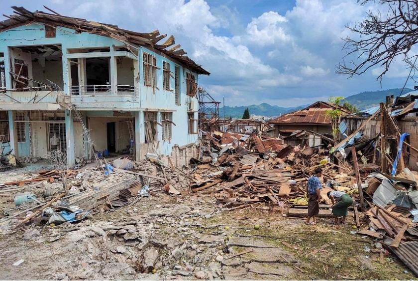 People cleaning up damaged buildings in the aftermath of bombardments carried out by Myanmar's military in Lashio in Myanmar, on Sept 24. PHOTO: AFP