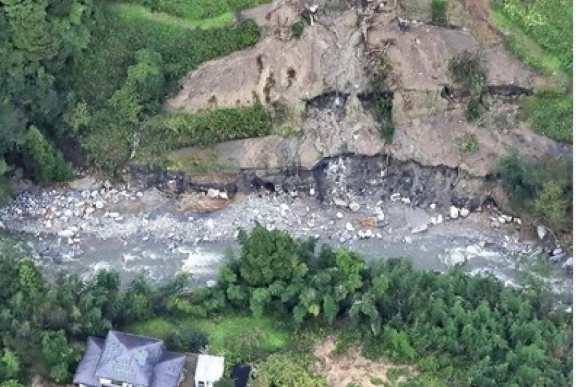 The kanji characters for “Water” and “Food” arranged using driftwood are seen at the bottom of the image near houses affected by the disaster in Marumori, Miyagi Prefecture, on Tuesday.
