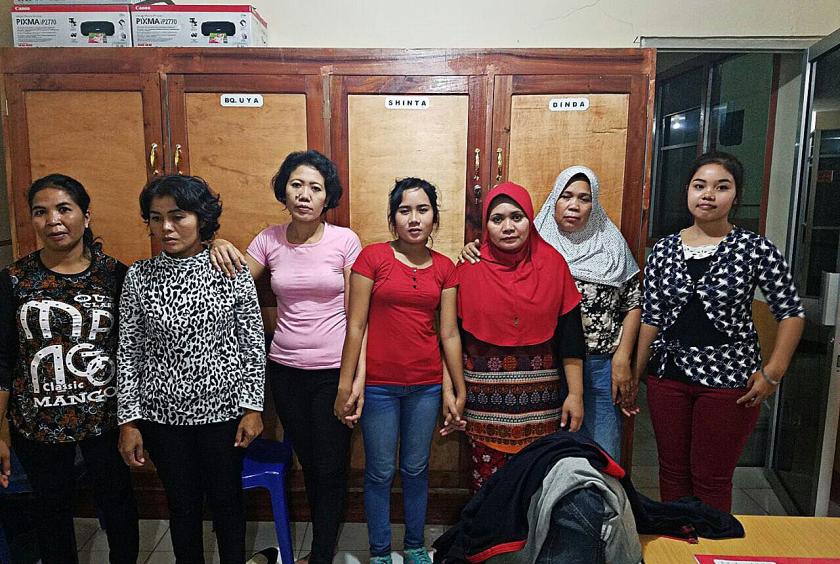 Seven women migrant workers from West Nusa Tenggara, who were rescued from a human trafficking network, pose for a picture together. (Courtesy of the West Nusa Tenggara Police/File)
