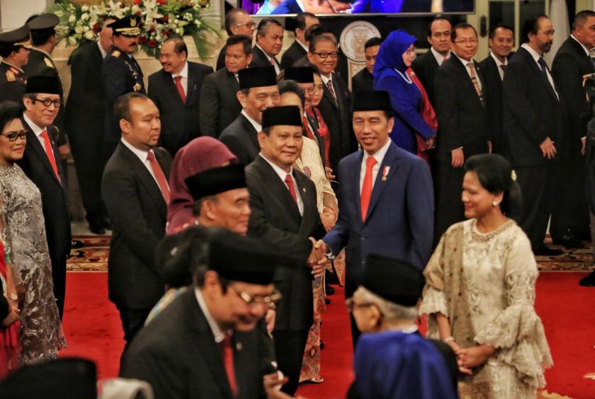 President Joko "Jokowi" Widodo greets Defense Minister Prabowo Subianto during the inauguration of Indonesia Onward Cabinet ministers on Wednesday at the State Palace. (JP/Seto Wardhana)