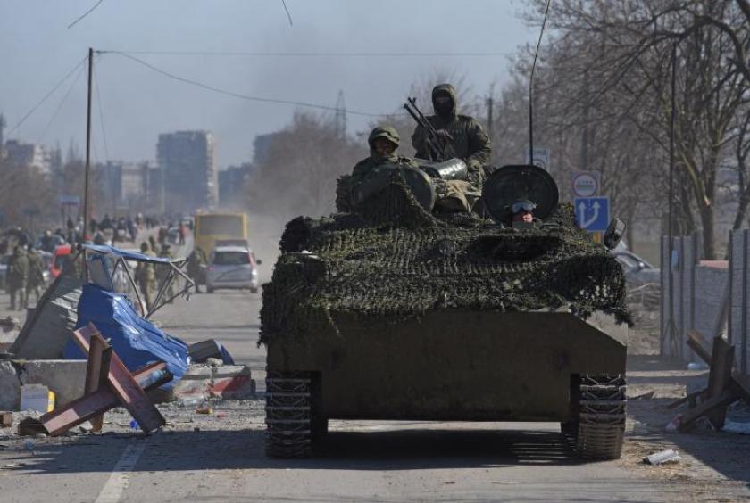 Pro-Russian troops in uniforms without insignia drive an armoured vehicle in Mariupol, on March 19, 2022. PHOTO: REUTERS