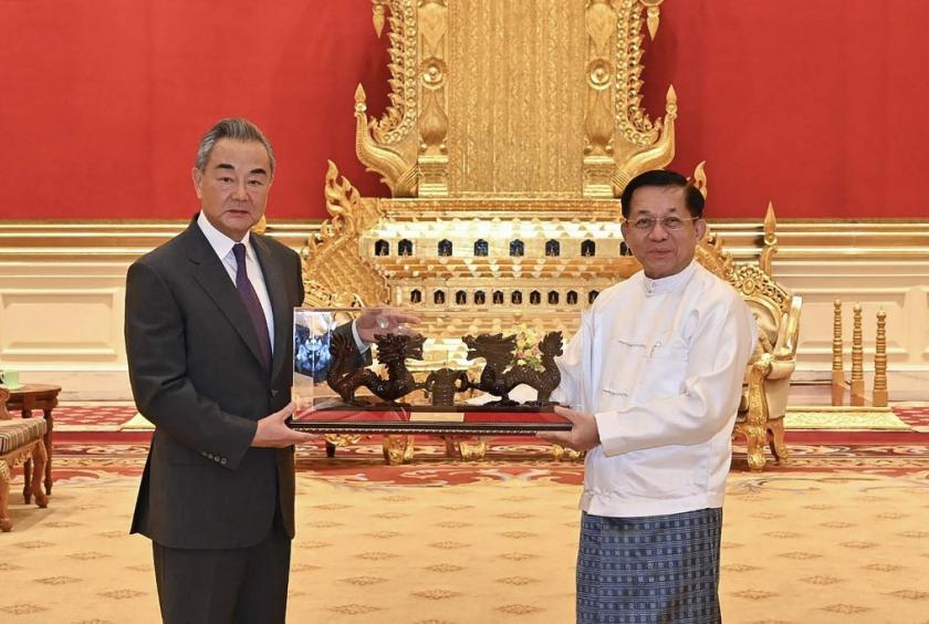 This photograph taken and released on August 14, 2024 by the Myanmar Military Information Team shows Myanmar's military chief Min Aung Hlaing (right) meeting with China's Foreign Minister Wang Yi in Naypyidaw. (AFP/Myanmar Military)