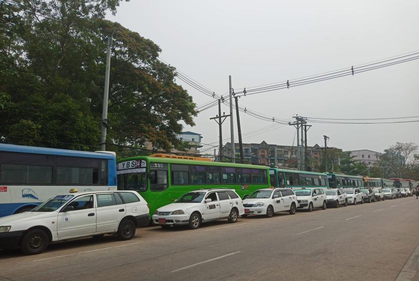 Vehicles wait in line in front of a CNG station in Yangon Region