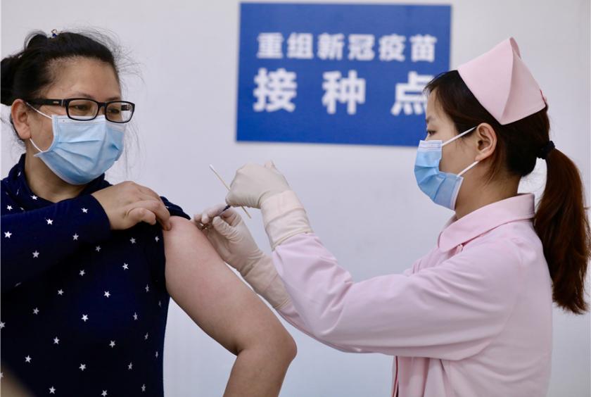 Wang Li, a 45-year-old volunteer, receives the recombinant novel coronavirus (COVID-19) vaccine inoculation in Wuhan, Central China's Hubei province, on March 24, 2020. [Photo by Zhu Xingxin/chinadaily.com.cn]