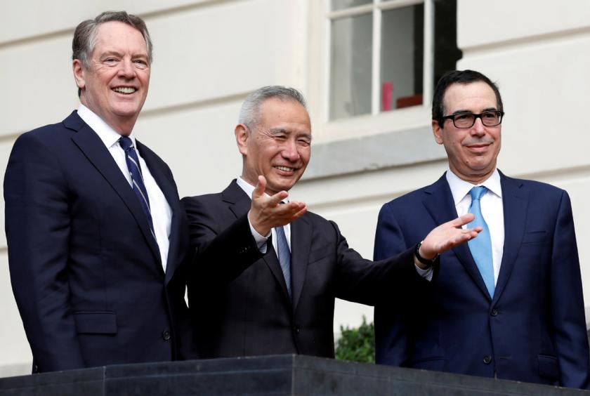 China's Vice-Premier Liu He gestures to the media between US Trade Representative Robert Lighthizer (L) and Treasury Secretary Steve Mnuchin before the two countries' trade negotiations in Washington, October 10, 2019. [Photo/Agencies]