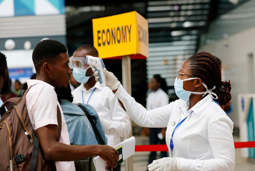 A health worker checks the temperature of a traveller as part of the coronavirus screening procedure at the Kotoka International Airport in Accra, Ghana, Jan 30, 2020. [Photo/Agencies]