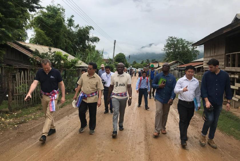 Mr Gilbert F. Houngbo (third from left) and Lao and UN officials tour a community where IFAD is funding a food security project.