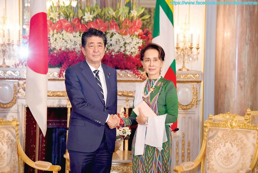 Myanmar State Counsellor Daw Aung San Suu Kyi shakes hands with Japanese Prime Minister Shinzo Abe. (photo-MOFA Myanmar)