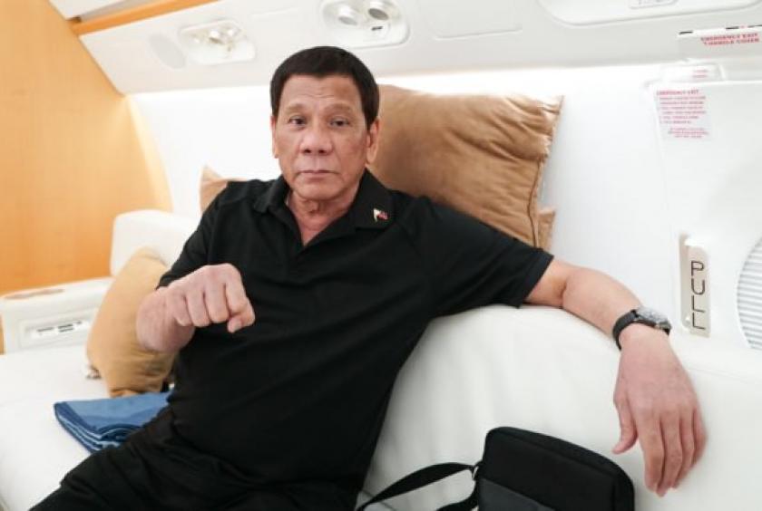 President Rodrigo Roa Duterte flashes his signature pose while on a plane bound for the People’s Republic of China at the Villamor Air Base in Pasay City on August 28, 2019. (Photo by KING RODRIGUEZ / Presidential Photographers Division) 