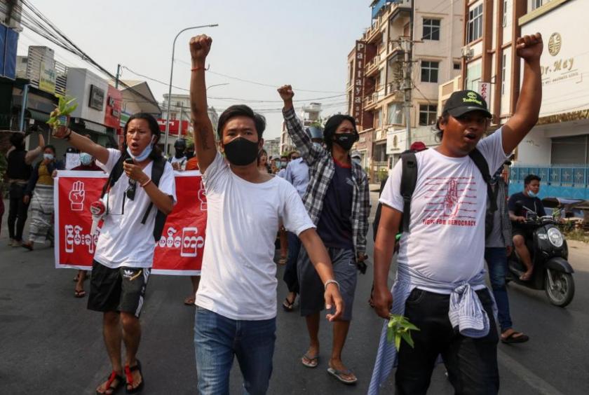 Demonstrators raise their fists as they march during an anti-military coup protest in Mandalay, Myanmar, on April 12, 2021.PHOTO: EPA-EFE