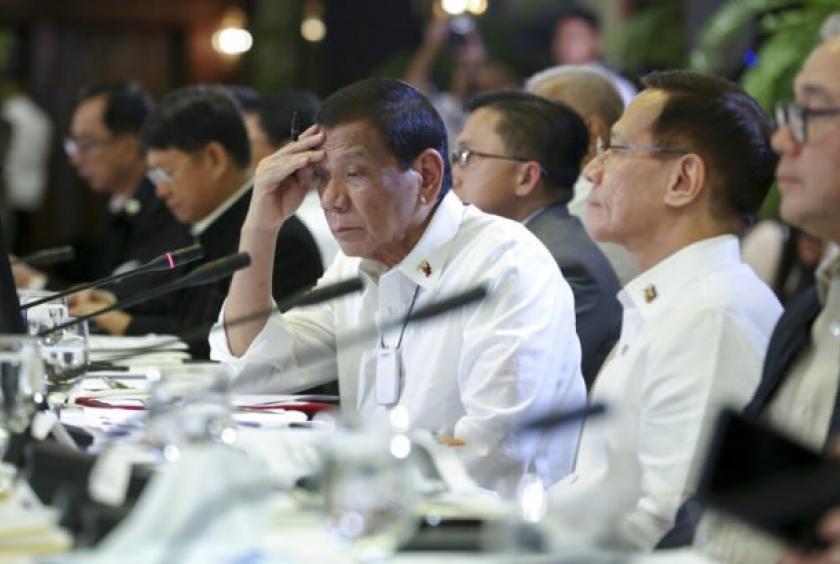 In this March 9, 2020, photo provided by the Malacanang Presidential Photographers Division, Philippine President Rodrigo Duterte, center, listens during a meeting with the Inter-Agency Task Force for the Management of Emerging Infectious Diseases at the Malacanang Palace in Manila, Philippines. Duterte has declared a state of public health emergency throughout the country after health officials confirmed over the weekend the first local transmission of the new coronavirus. (Albert Alcain/Malacanang Preside