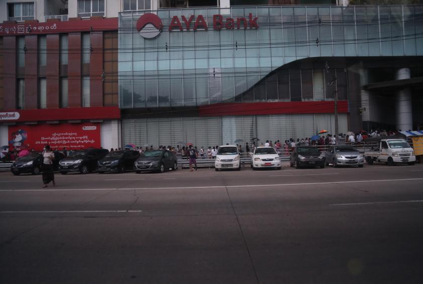People queue up for the ATM along Strand Road in Yangon on April 30. (Photo - Thiha Aung)