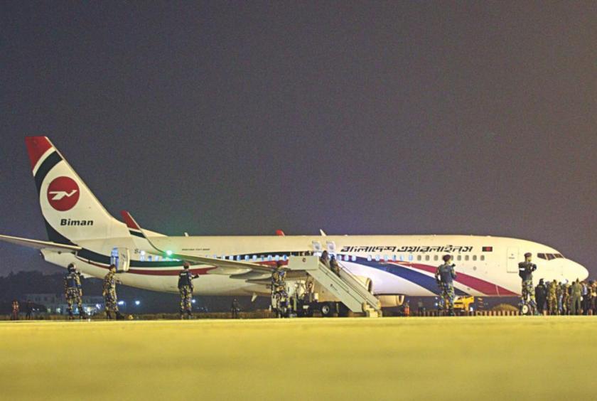 Security personnel surrounding a Boeing 737-800 of Biman during a standoff with a man who attempted to hijack the plane. Photo: Rajib Raihan