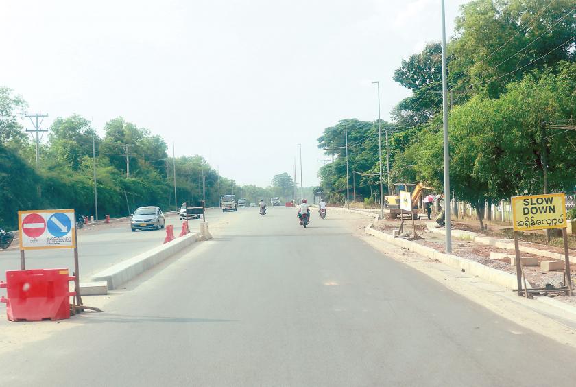 The four-lane tarred road is under construction in Thanlyin Township, Yangon Region. (Photo-Thiha Aung)