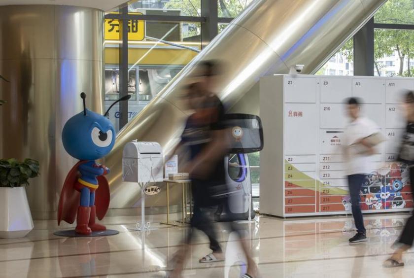 People walk past the Ant Group Co mascot displayed at the company's headquarters in Hangzhou, China, Sept 28, 2020. (PHOTO/BLOOMBERG)