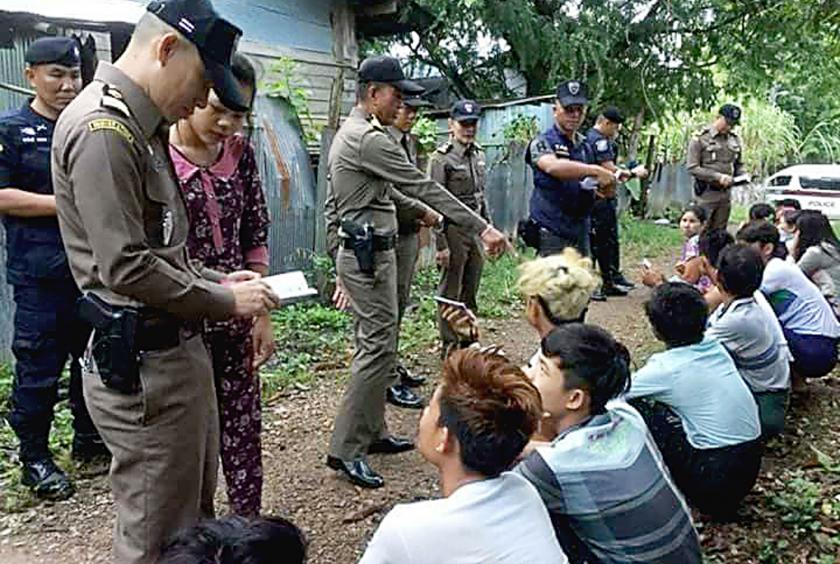 Authorities checking documents from Myanmar migrant workers in Mae Sot