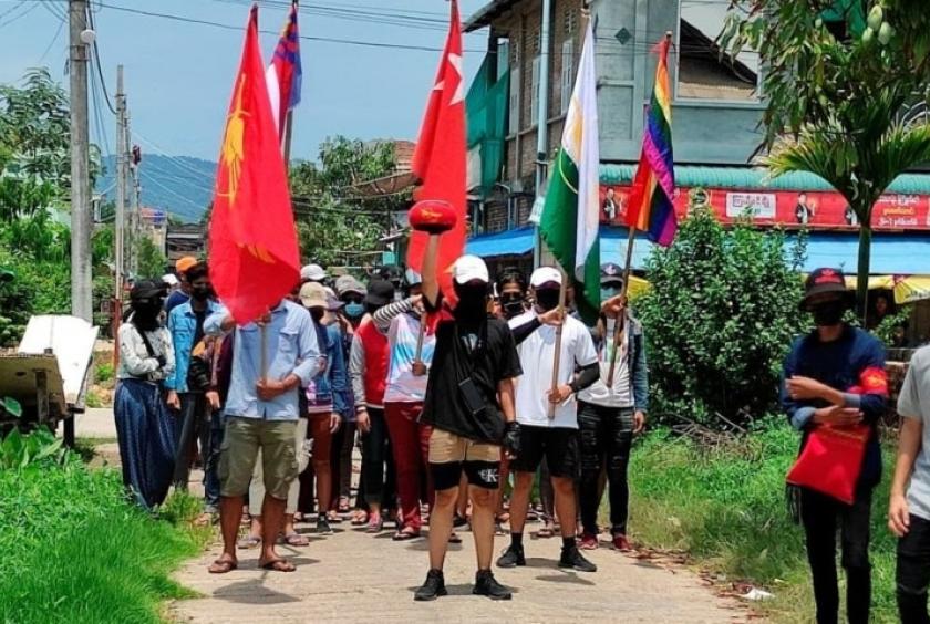 Demonstrators carry flags as they march to protest against the military coup, in Dawei, Myanmar, April 27. — Reuters