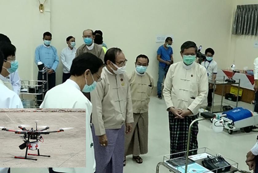 Officials view trolley robots donated by the Ministry of Education while smaller photo shows a drone with a loud speaker