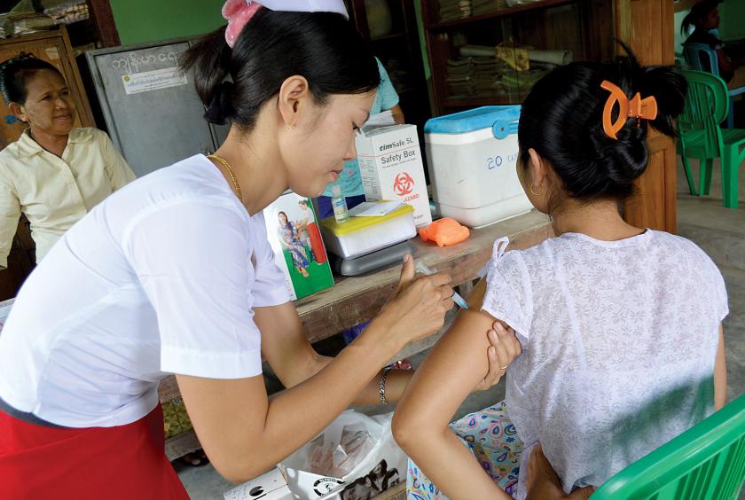 A nurse injects tetanus vaccine into a woman. (photo-Eithinzar Kyaw)