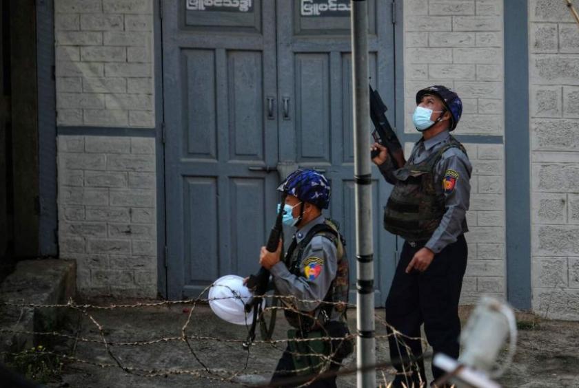 Myanmar security forces holding their weapons as they look from up on a street in Taunggyi in Shan state, Myanmar, on March 25, 2021.PHOTO: AFP/FACEBOOK