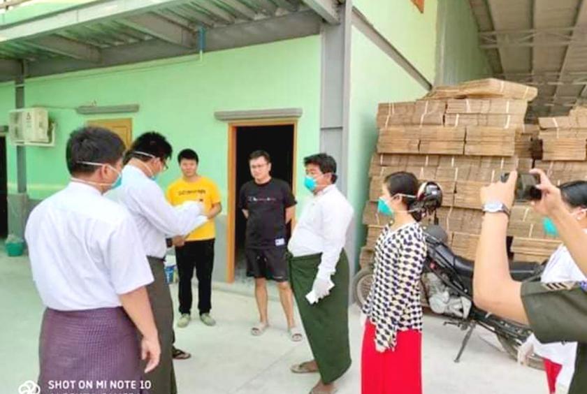 Authorities check two Chinese citizens at Shwe Thonelone carton box factory
