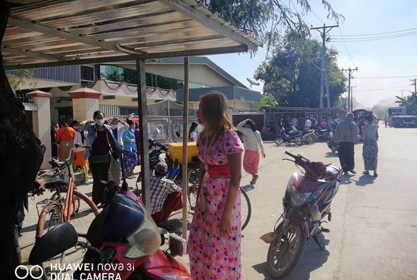 Some workers from Houng Yun (Myanmar) Garment Factory seen in front of the factory 