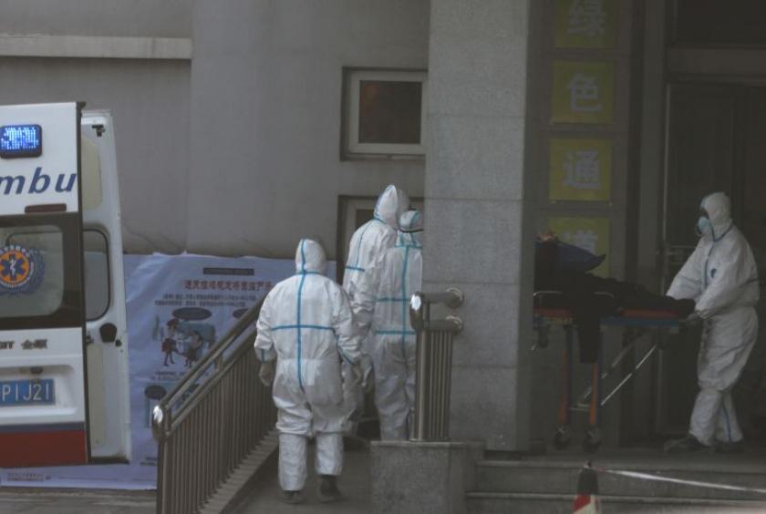 Medical staff transfer a patient from an ambulance at the Jinyintan hospital, where the patients with pneumonia caused by the new strain of coronavirus are being treated, in Wuhan, Hubei province, on Jan 20, 2020.PHOTO: REUTERS