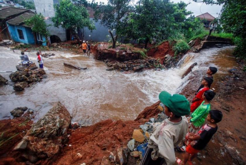 People gather around a dam which collapsed after heavy rains in West Java, on Jan 2, 2020.PHOTO: REUTERS/ANTARA FOTO