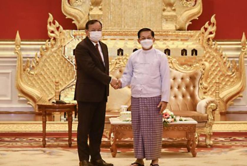 Foreign minister Prak Sokhonn (left) shakes hands with SAC chairman Senior General Min Aung Hlaing in Myanmar on Monday. MFAIC