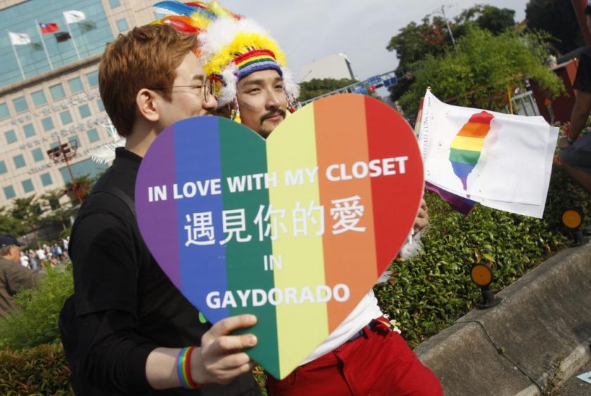 Participants revel through a street during a gay and lesbian parade in Taipei, Taiwan, Saturday, Oct. 28, 2017. Taiwan’s Constitutional Court ruled in favor of same-sex marriage on May 24, 2017, making the island the first place in Asia to recognize gay unions. (AP Photo/Chiang Ying-ying)