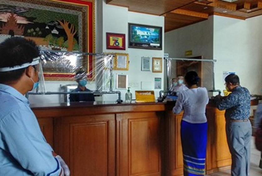 Health officials check a hotel in Mandalay