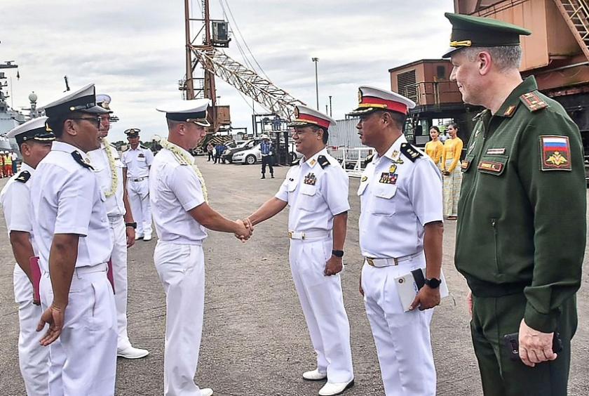 A Myanmar's military official shaking hands with a member of the Russian Navy ahead of joint maritime exercises at Thilawa Port in Yangon. PHOTO: AFP