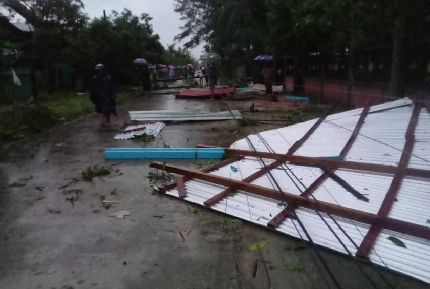 Homes and power poles damaged after a tornado struck Nyaung Waing village in Paung Township.