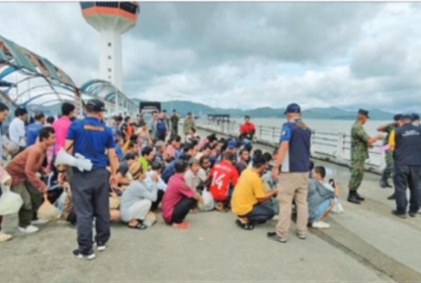 Photo shows repatriated Myanmar workers.
