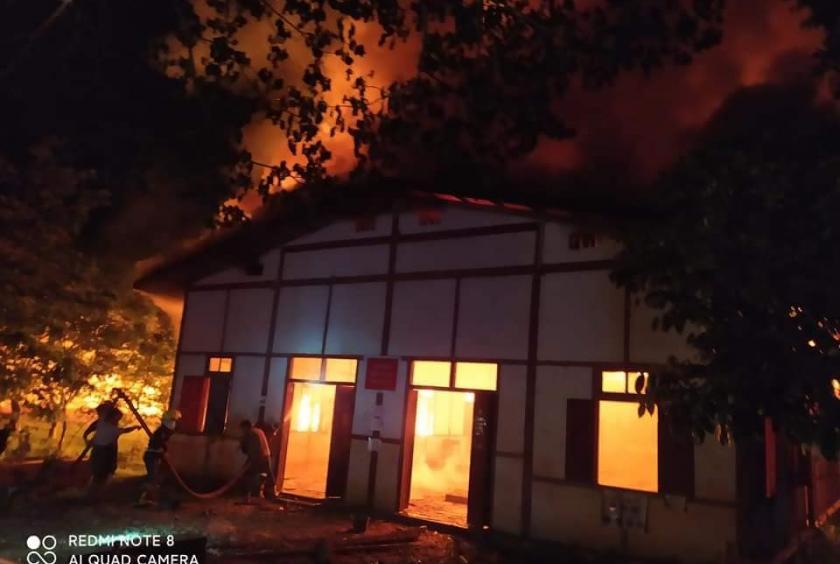 Firefighters try to put out a fire at a school in Indawgyi.