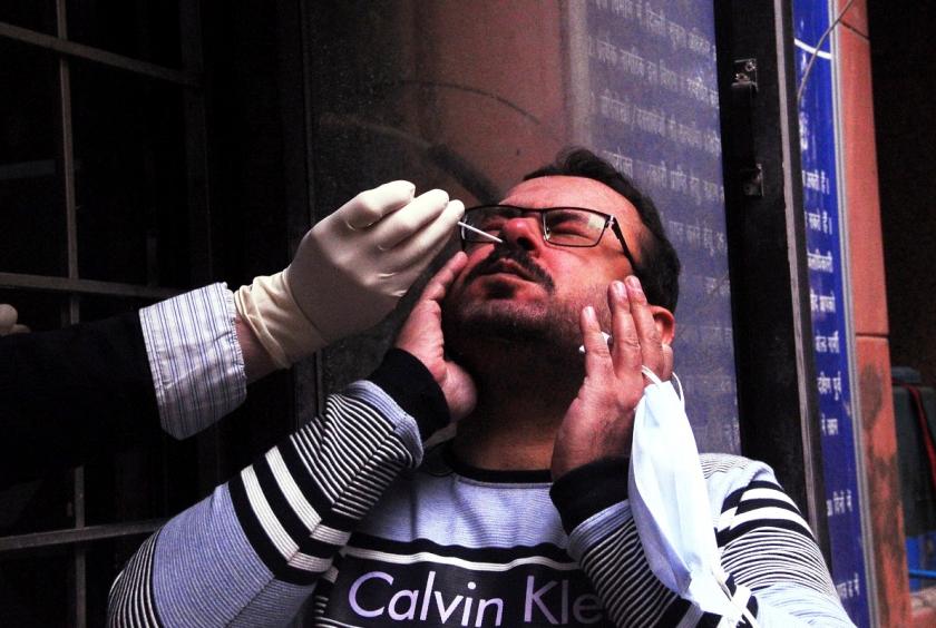 A man gives swab samples for COVID-19 testing at the District magistrate office (SDM) Lajpat Nagar in New Delhi. (Photo: IANS)