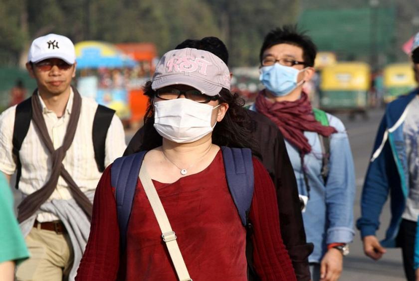 People wearing masks as a precautionary measure against swine flu. (File Photo: IANS)