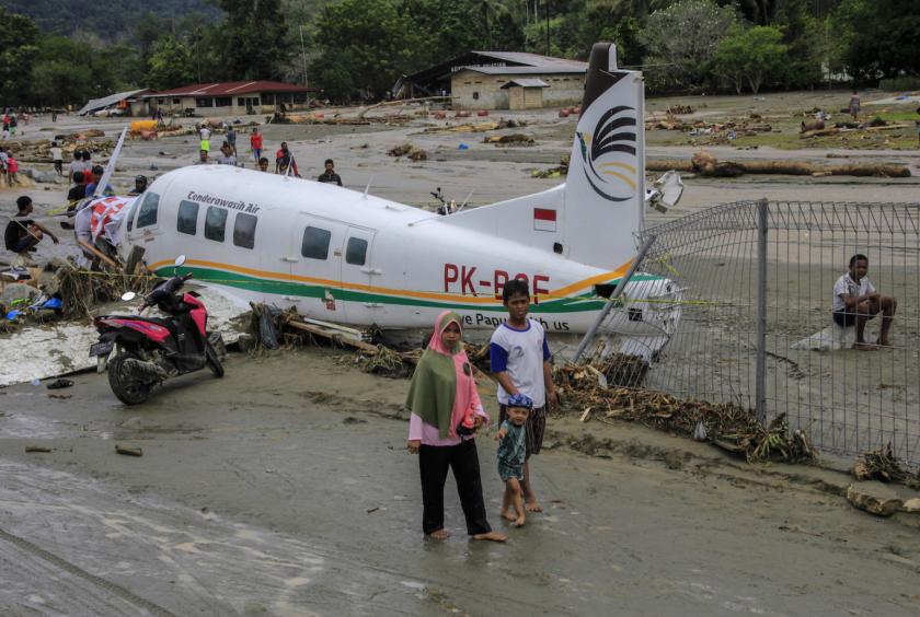 Baby reunited with dad as Indonesia flood death toll hits 77