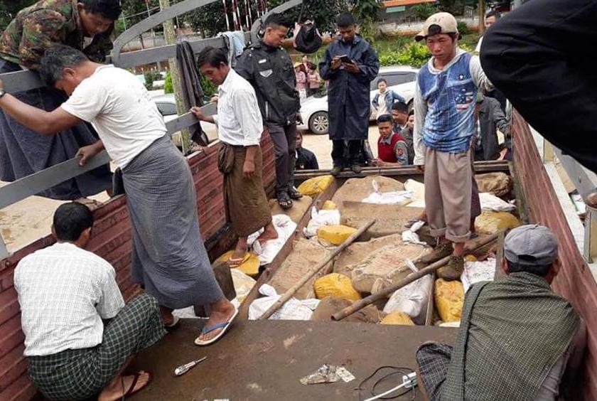 Authorities check seized jade stones from the 12-wheeled truck in Kyaukme