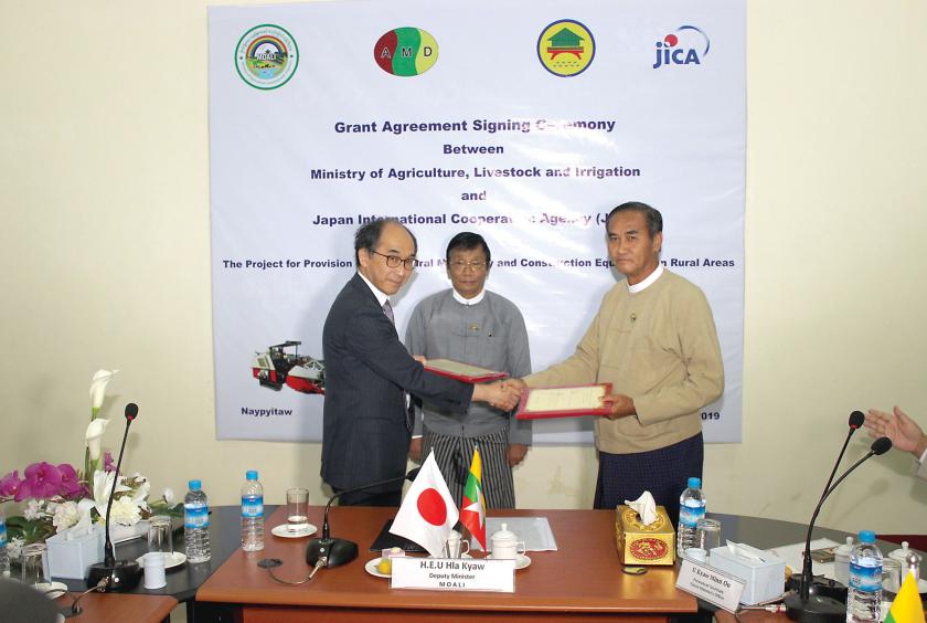 The officials of Myanmar and Japan exchange documents after signing grant agreement.