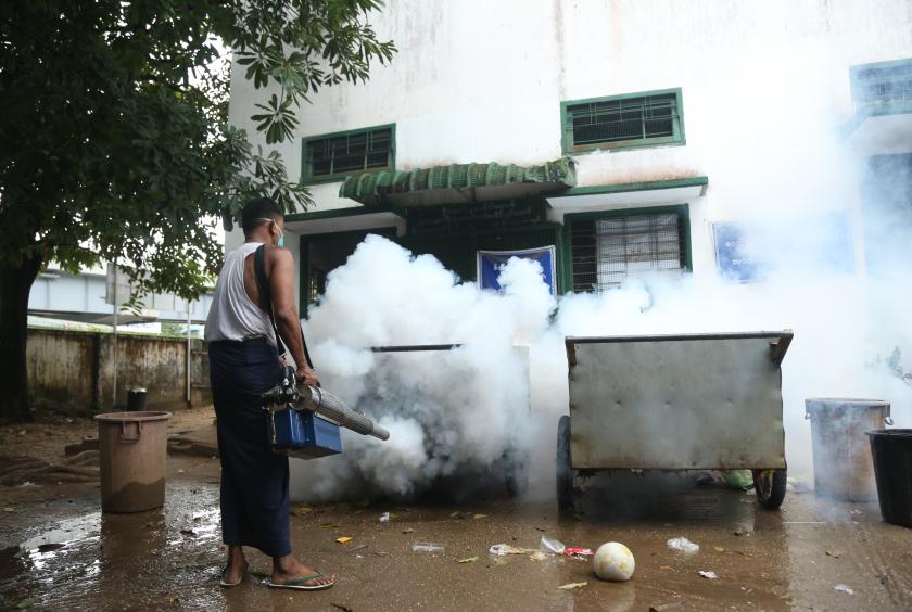 A man fumigates a building in Tamwe Township in Yangon. (Photo-Kyi Naing)
