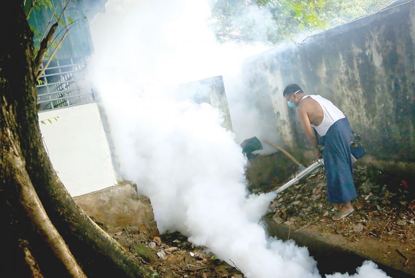 A man fumigates the place in Tamwe Township. (Photo-Kyi Naing)