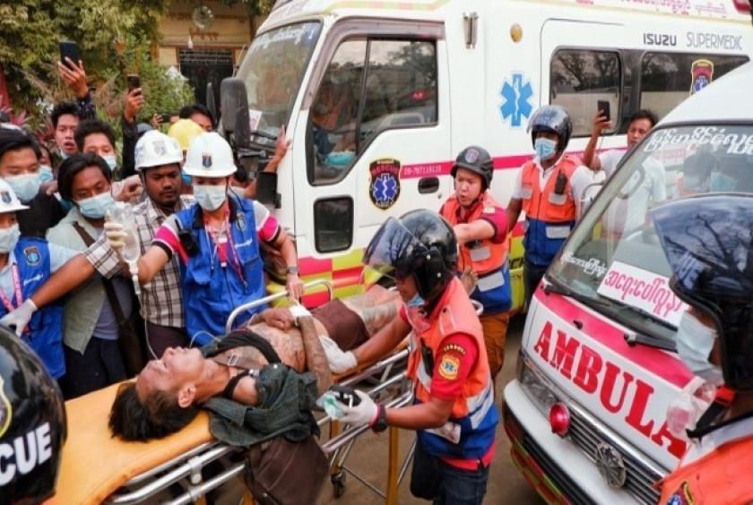 A Myanmar citizen who protested against the military coup gets transported by paramedics on Feb. 20. (Yonhap)