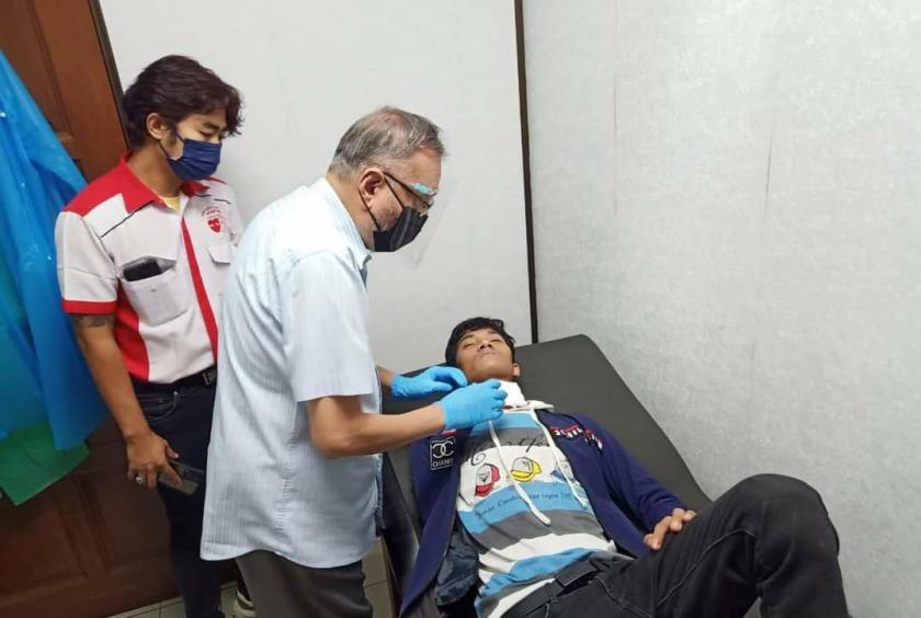 The victim receiving medical treatment. 