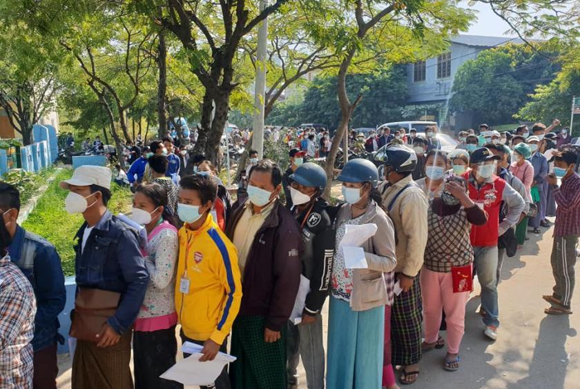 People lining up at Pyigyitagon Administration Office to get permission to go outside on December 8