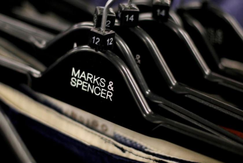 Clothes are displayed on hangers in an Marks & Spencer shop in northwest London, Britain July 8, 2014. Photo: REUTERS/Suzanne Plunkett/File Photo